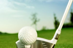 Golf equipment, golf ball with tee on course and stick